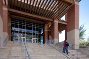 Student walking up stairs of student rec center.